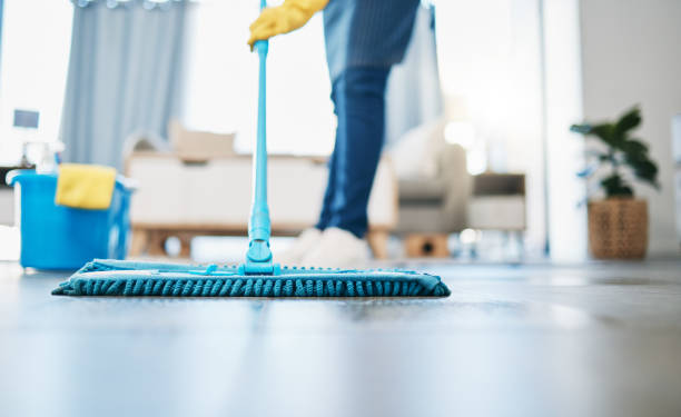 A woman is engaged in mopping the floor, highlighting the importance of Eco-friendly Cleaning Companies.