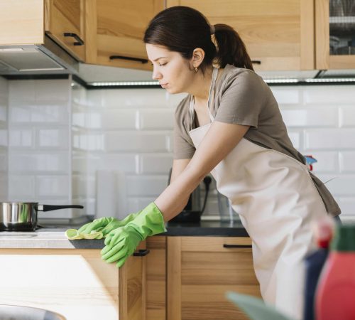 woman-wearing-green-rubber-gloves-min